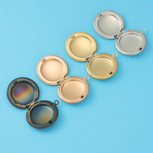 Detail of round 316L stainless steel lockets in black, gold, rose gold and silver finishes