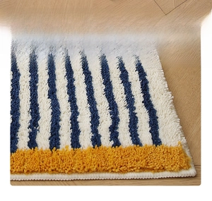 Close-up of thick blue and white striped rug with soft yellow trim and neat stitching