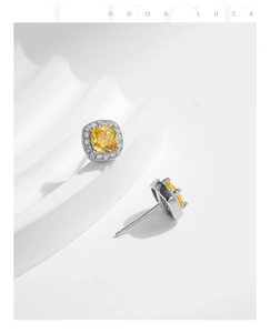 Detail of luxury S925 silver stud earrings with cushion-cut yellow diamonds and pavé stones