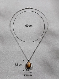 Detailed view of vintage tiger eye pendant necklace with 60cm rope chain and moon detail