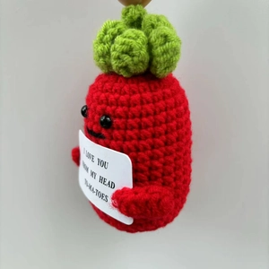 Detail of a handmade crochet tomato doll with a funny I LOVE YOU pun gift card