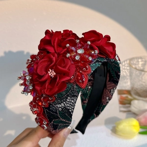 Detail of handmade fabric flower headband with red beads, rhinestones and black lace