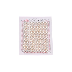 Natural white half-drilled freshwater button pearls neatly arranged for jewelry making