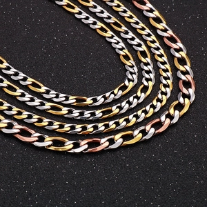 Detailed close-up of a three-tone Cuban link necklace in silver, gold, and rose gold finishes