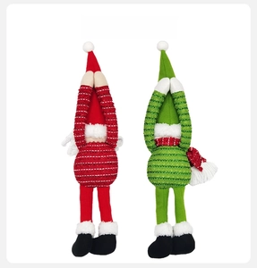 Rear view of Christmas elf dolls with long striped legs and plush pom-poms on hats
