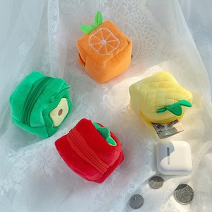 Mini plush fruit-shaped coin purses featuring orange strawberry avocado and pineapple