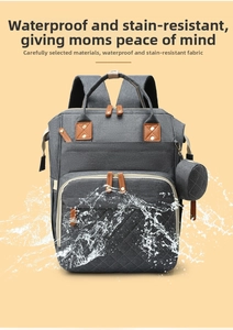 Close-up of waterproof dark gray diaper bag showing water splashes and premium fabric