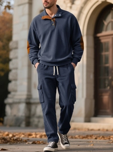 Close-up of men's navy corduroy jacket detailing elbow patches and buttoned collar