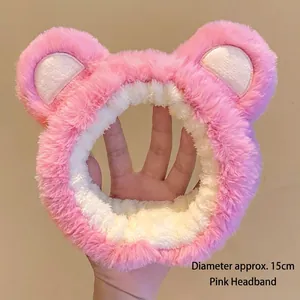 Detail showing plush pink strawberry bear headband texture with 15cm diameter size