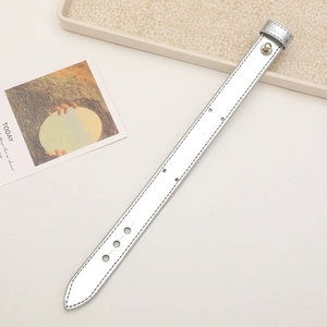Close-up of silver reflective leather wrist strap with adjustable buckle and metal button