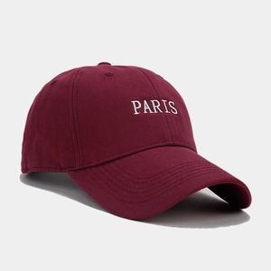 Detailed embroidery of white PARIS text on a premium burgundy cotton baseball cap