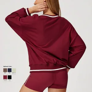 Women's burgundy colorblock sweatshirt and biker shorts set with white stripe accents