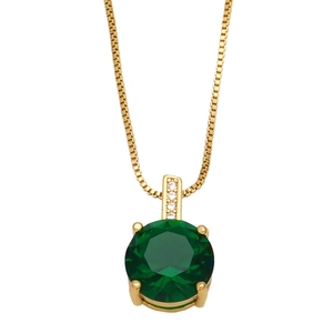 Close-up of a gold box chain with a deep green zircon pendant in a four-claw setting