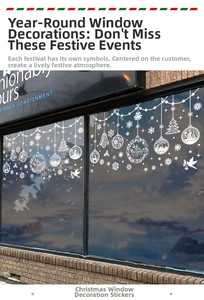 Close-up of white Christmas snowflake and bell window stickers on a glass storefront