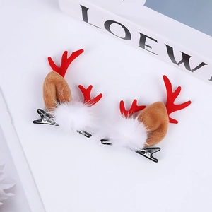 Detailed close-up of Christmas deer horn hair clips with red antlers and plush ears