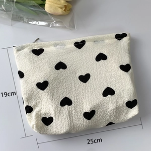 Detail of heart pattern toiletry bag in bubble cotton with size dimensions 25x19cm