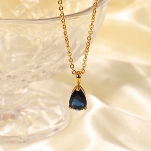 Detail of 18K gold plated teardrop necklace with a deep blue zircon birthstone pendant