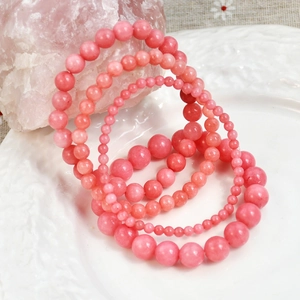 Pink rhodochrosite beaded bracelet set with four pieces of varying bead sizes
