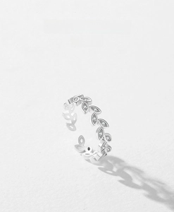Macro detail of S925 sterling silver leaf ring with pavé-set shimmering cubic zirconia