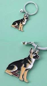 Detail view of German Shepherd enamel keychain with silver bell and metal ring