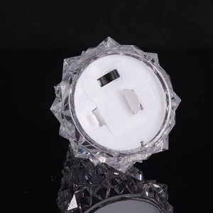 Transparent crystal Christmas tree night light with LED illumination on black reflection