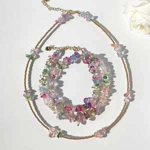 Detail of colorful gemstone beads and gold beads on summer beach necklace and bracelet