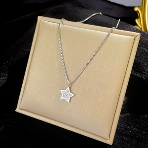 Macro shot of silver star pendant with pave crystals on a durable box chain necklace