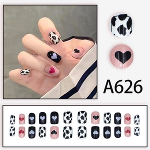 Detailed set of A626 almond press-on nails with cow print and heart patterns in pink and black