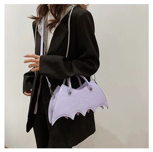 Detail of purple bat-wing PU leather handbag with spiderweb stitching and skull hardware