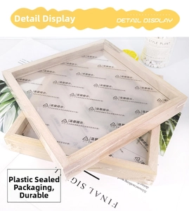 Detail view of two natural wood square frames with protective plastic film and wood grain