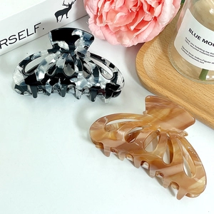 Set of two elegant acetate hair claws in marble and tortoiseshell patterns with flowers