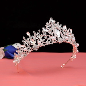 Detail of silver bridal crown featuring shimmering crystals and white faux pearls decor
