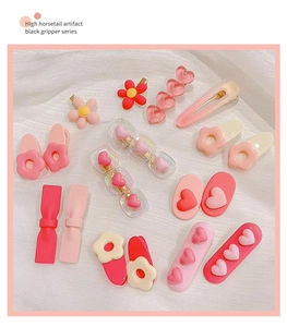 Flat lay of pink heart and flower hair clips set for girls featuring Y2K style aesthetic