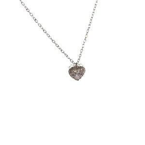 Close-up of heart-shaped silver necklace featuring a central zircon and pavé halo detail