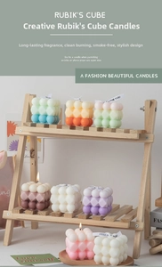 Macro view of bubble cube candles in pastel colors on a wooden display shelf