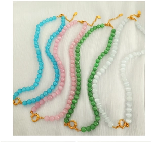 Detailed view of faceted cat eye stone bead necklaces with golden toggle clasp and extender