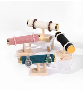 Detail of T-bar jewelry stands with wood bases and colorful velvet cylinders in four colors