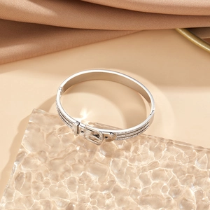 Close-up of silver belt buckle bracelet with triple row of micro-paved zircons