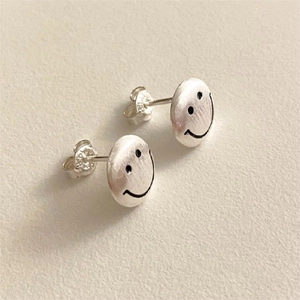 Detailed close-up of 925 sterling silver smiley face stud earrings with a brushed finish