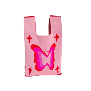 Pink knit tote bag with red butterfly and star patterns on a clean white background