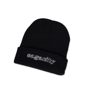 Close-up of black knit beanie with white Sagacity embroidery on the folded cuff