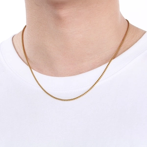 Close-up of a minimalist golden stainless steel basket chain necklace on a model's neck