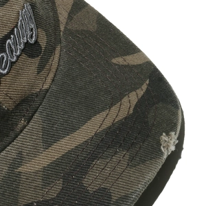 Detailed close-up of 3D embroidery on camouflage baseball cap with distressed brim