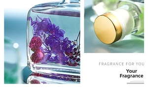 Close-up of elegant glass diffuser bottle with purple dried flowers and gold metal lid