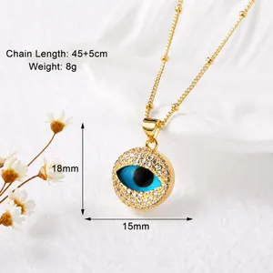 Detail of 18k gold heart necklace with blue evil eye pendant and zircon stones