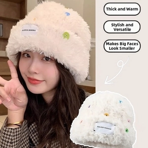 Detail of white faux fur bucket hat featuring colorful buttons and plush texture for winter