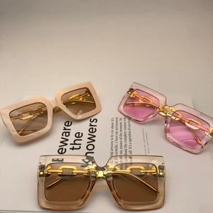 Chic oversized square sunglasses with gold chain temples in beige, pink, and tea colors