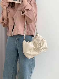 Chic beige ruched shoulder bag with silver chain strap and three decorative bows