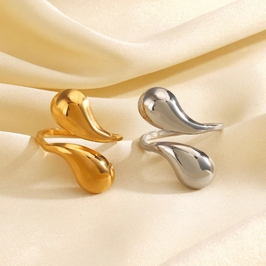 Minimalist fluid water drop rings in 18K gold and silver plating on satin background