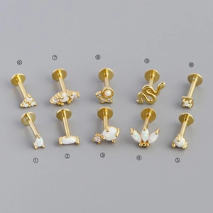 Detailed set of ten gold S925 earrings with white opal and clear zircon stone accents